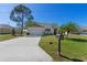 Charming single-story home with well-manicured lawn, mature trees, and a welcoming two car garage at 25199 Chiclayo Ave, Punta Gorda, FL 33983