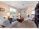 Comfortable living room featuring neutral tones, soft lighting, and large windows offering natural light at 25199 Chiclayo Ave, Punta Gorda, FL 33983
