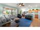 Comfortable living room features ample natural light, wood flooring, and a ceiling fan at 25199 Chiclayo Ave, Punta Gorda, FL 33983