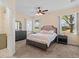 Cozy main bedroom featuring a ceiling fan, neutral carpet, and large window at 25199 Chiclayo Ave, Punta Gorda, FL 33983