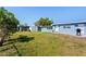 The spacious backyard includes lush greenery and a shed, ideal for outdoor activities at 3124 Crestwood Dr, Port Charlotte, FL 33952