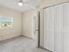 A bedroom with a ceiling fan, closet, and natural light from a window at 3124 Crestwood Dr, Port Charlotte, FL 33952