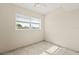 Bright bedroom with a window, neutral color, tiled floor, and a ceiling fan at 3124 Crestwood Dr, Port Charlotte, FL 33952