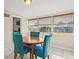 Cozy dining area with a round table and bright blue chairs under natural light at 3124 Crestwood Dr, Port Charlotte, FL 33952