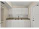 Stylish kitchen boasting white cabinetry, granite countertops, and a clean, functional design at 3124 Crestwood Dr, Port Charlotte, FL 33952