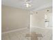 Inviting living room with neutral walls, tile flooring, and seamless flow into the kitchen at 3124 Crestwood Dr, Port Charlotte, FL 33952