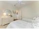 Bright bedroom with twin beds, a dresser, and an attractive mirror and neutral decor at 333 Santander Ct, Punta Gorda, FL 33950