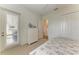 Bedroom with white dresser, patio access, and ensuite bathroom entry at 333 Santander Ct, Punta Gorda, FL 33950