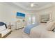 Serene bedroom features a queen bed, decorative dresser, and french doors leading to the outside at 333 Santander Ct, Punta Gorda, FL 33950