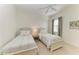 Bedroom with two twin beds, neutral tones, and a ceiling fan at 333 Santander Ct, Punta Gorda, FL 33950