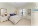 Bedroom with a ceiling fan, white furniture, and patterned bedding at 333 Santander Ct, Punta Gorda, FL 33950