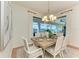 Charming dining room with chandelier, large windows, and seating for six provides a bright and inviting space at 333 Santander Ct, Punta Gorda, FL 33950