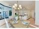 Open-concept dining area with chandelier adjacent to living room and gourmet kitchen at 333 Santander Ct, Punta Gorda, FL 33950