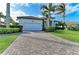 Charming home features a brick-paved driveway, a two-car garage, and professionally landscaped front yard at 333 Santander Ct, Punta Gorda, FL 33950