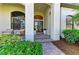 Inviting home entrance featuring double doors, stately pillars, and attractive landscaping at 333 Santander Ct, Punta Gorda, FL 33950