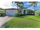 Home's exterior with meticulous landscaping, large driveway, and arched entrance, displaying curb appeal at 333 Santander Ct, Punta Gorda, FL 33950