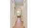 Hallway with wood flooring and white trim, leading to a bright and airy room at 333 Santander Ct, Punta Gorda, FL 33950
