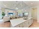 Bright, open kitchen with large island, pendant lighting, and hardwood floors flows into the living room at 333 Santander Ct, Punta Gorda, FL 33950