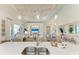 Stylish kitchen island with quartz countertops, sink, and seating overlooks living room and backyard at 333 Santander Ct, Punta Gorda, FL 33950