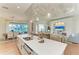 Beautiful kitchen island with quartz countertops, sink, and seating with open access to backyard at 333 Santander Ct, Punta Gorda, FL 33950
