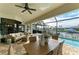 Spacious screened lanai featuring a pool, dining, lounge, and waterfront views at 333 Santander Ct, Punta Gorda, FL 33950