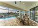 Outdoor dining on a covered lanai with a waterfront view and outdoor bar at 333 Santander Ct, Punta Gorda, FL 33950