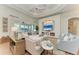 Bright living room with large windows, a decorative fireplace, and comfortable seating at 333 Santander Ct, Punta Gorda, FL 33950