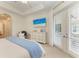 Bright main bedroom with white dresser, ceiling fan, and patio door access at 333 Santander Ct, Punta Gorda, FL 33950