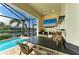 Outdoor kitchen and bar area by the pool, perfect for entertaining and enjoying waterfront scenery at 333 Santander Ct, Punta Gorda, FL 33950