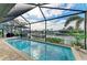Sparkling screened-in pool with waterfront views and lush landscaping at 333 Santander Ct, Punta Gorda, FL 33950