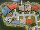 Drone shot of the house located on a circle, highlighting its lanai, pool, boat lift and proximity to the water at 3335 Grenada Ct, Punta Gorda, FL 33950