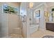 Bathroom featuring a walk-in shower, a separate soaking tub, and natural light from a window at 3335 Grenada Ct, Punta Gorda, FL 33950