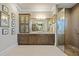 Elegant bathroom with double vanities, a large mirror, and a glass enclosed shower at 3335 Grenada Ct, Punta Gorda, FL 33950