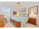 Bright bedroom features a four-poster bed, neutral decor, and natural light from a window with shutters at 3335 Grenada Ct, Punta Gorda, FL 33950