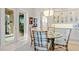 Cozy dining space features a glass table, seating for four, and is adjacent to a bright kitchen at 3335 Grenada Ct, Punta Gorda, FL 33950