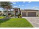 Beautiful single-story home with lush landscaping, a paver driveway, and a three-car garage at 3335 Grenada Ct, Punta Gorda, FL 33950