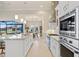 Spacious kitchen boasts stainless appliances, sleek countertops, and seamless transition to outdoor dining area at 3335 Grenada Ct, Punta Gorda, FL 33950
