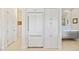 Kitchen boasts stainless refrigerator, pantry and access to hall with entry to bathroom at 3335 Grenada Ct, Punta Gorda, FL 33950