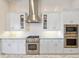 Modern kitchen with stainless steel appliances, bright lighting, and sleek white cabinets for a clean aesthetic at 3335 Grenada Ct, Punta Gorda, FL 33950
