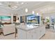 Well-lit kitchen flows into living area with water views, featuring island with seating and modern appliances at 3335 Grenada Ct, Punta Gorda, FL 33950