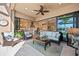 Inviting screened-in lanai featuring outdoor seating, a ceiling fan, and a view of the indoor living spaces at 3335 Grenada Ct, Punta Gorda, FL 33950