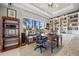 Bright office features a large window with a water view, neutral decor, and built-in shelving at 3335 Grenada Ct, Punta Gorda, FL 33950
