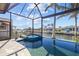Captivating pool and spa enclosed within a screened lanai, offering serene canal views at 3335 Grenada Ct, Punta Gorda, FL 33950
