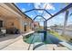 Stunning screened-in pool area with a spacious deck, lounge chairs, and views of the canal at 3335 Grenada Ct, Punta Gorda, FL 33950