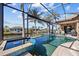 Breathtaking pool and spa area enclosed in a screened lanai, with expansive canal views at 3335 Grenada Ct, Punta Gorda, FL 33950