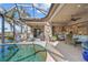 Gorgeous pool and lanai area offering comfortable seating, a ceiling fan, and access to the canal at 3335 Grenada Ct, Punta Gorda, FL 33950