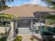 Screened lanai and pool deck featuring covered seating area and private pool surrounded by tropical landscaping at 3335 Grenada Ct, Punta Gorda, FL 33950