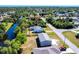 Aerial view of a charming single-story home with a well-manicured lawn and a gray roof at 410 Hinton St, Port Charlotte, FL 33954