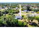 Aerial view of a charming single-story home with a well-manicured lawn and a gray roof at 410 Hinton St, Port Charlotte, FL 33954