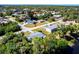 Aerial view of the home showing it's location within a community with mature trees at 410 Hinton St, Port Charlotte, FL 33954